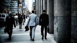 business people walking on sidewalk